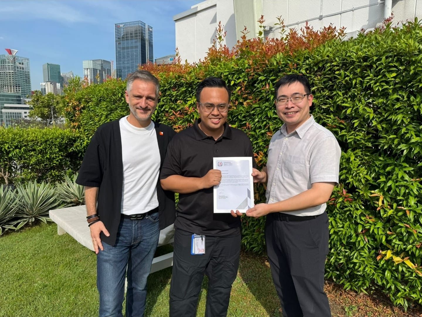 Hawkeye Security receiving the Singapore Police Force Letter of Appreciation, Marina Bay skyline behind