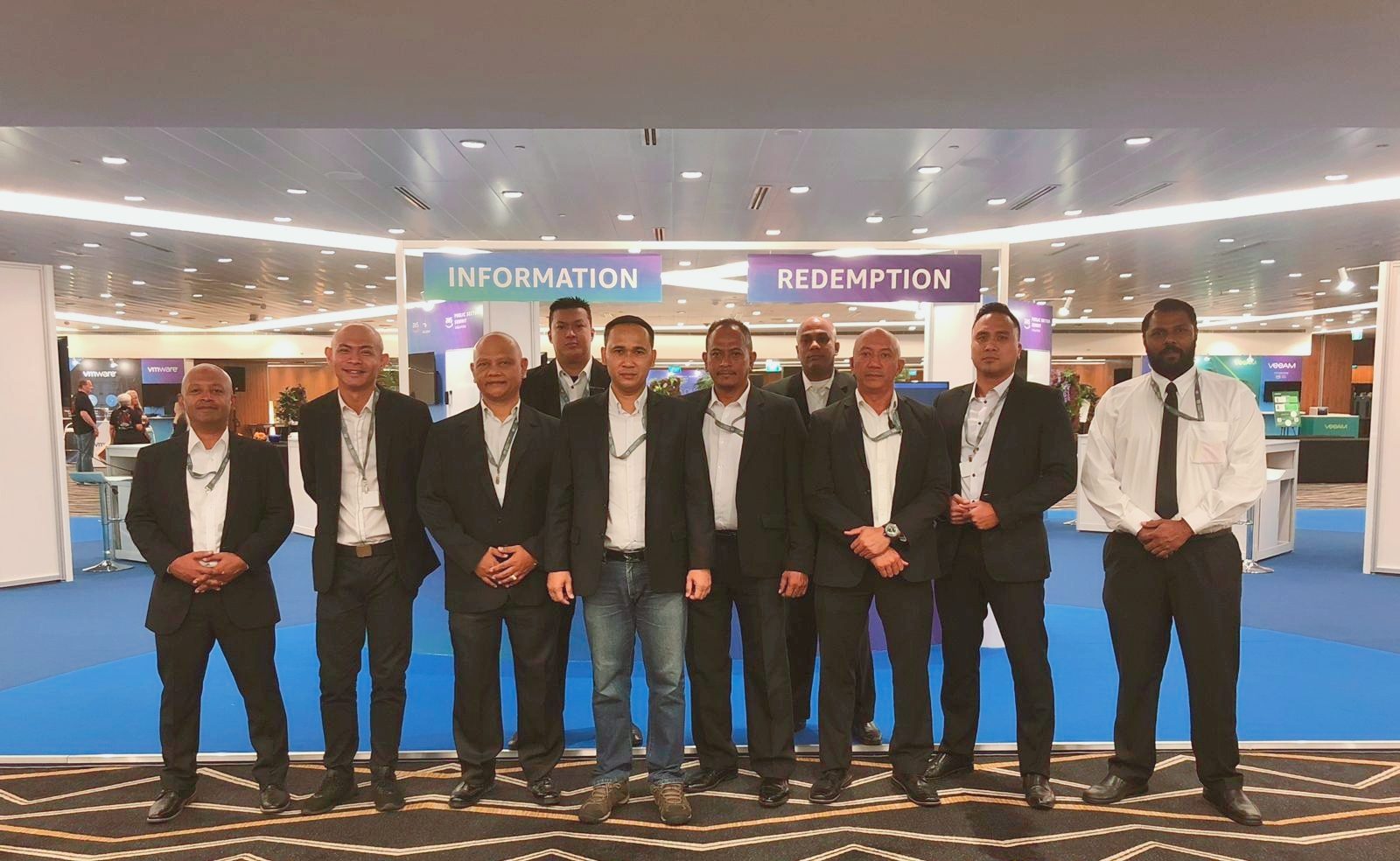 A Hawkeye supervisory team in suits at a Singapore convention